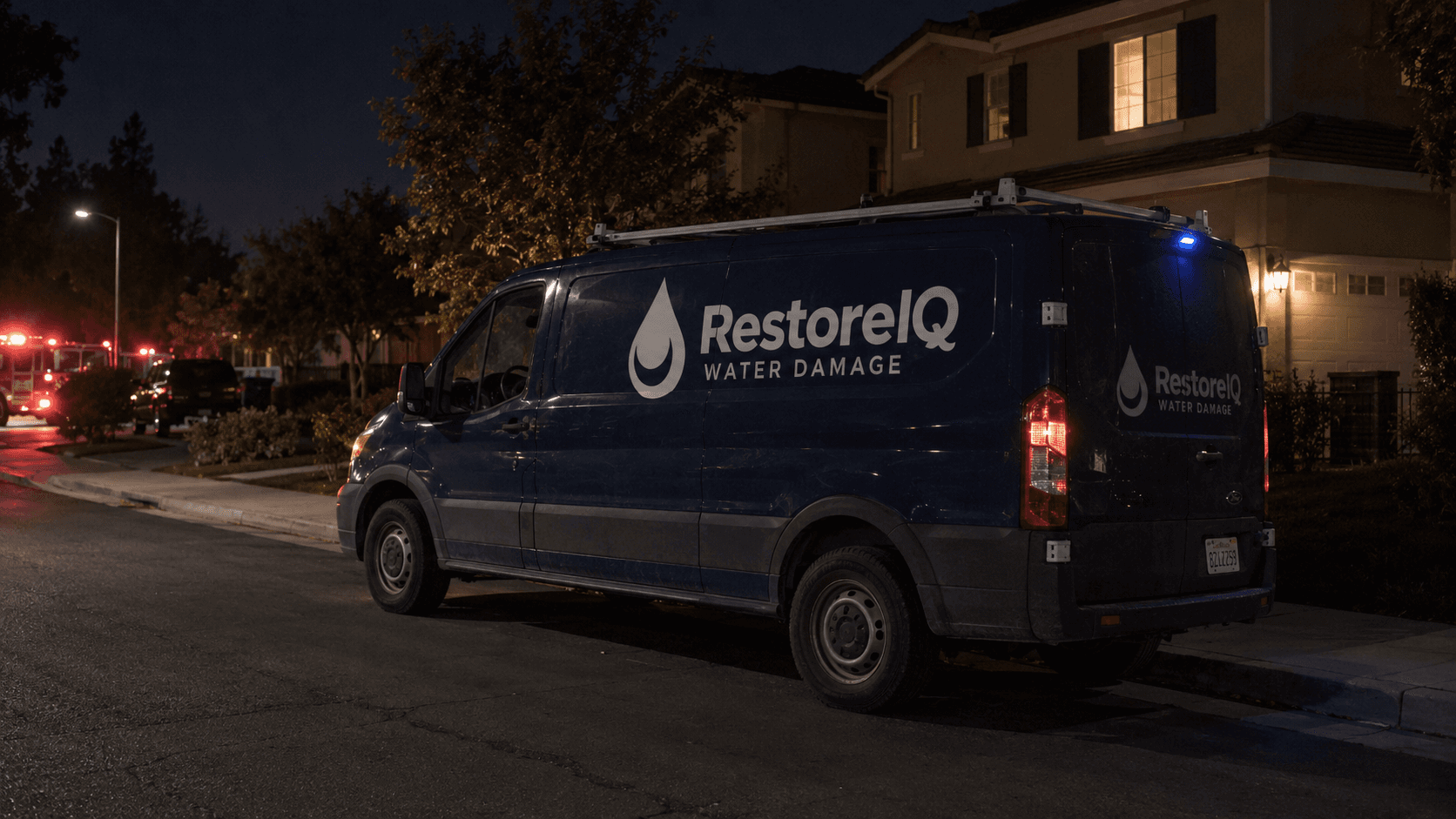 RestoreIQ service van responding to a residential property at night