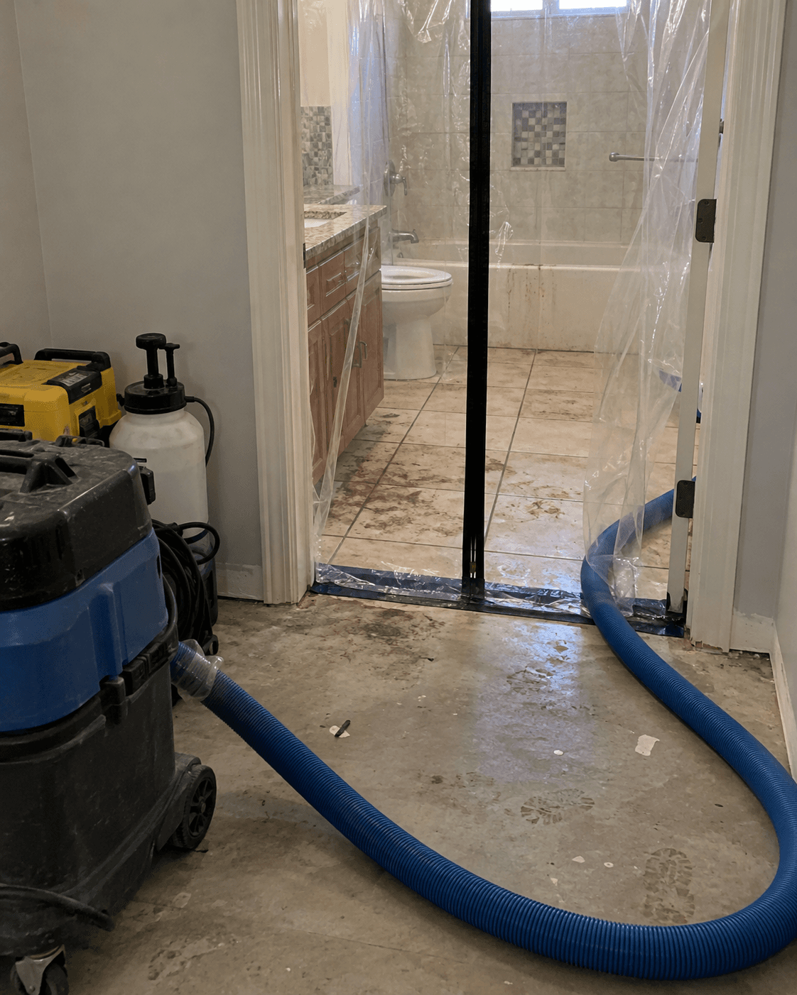 Containment at a bathroom doorway during contaminated-water cleanup